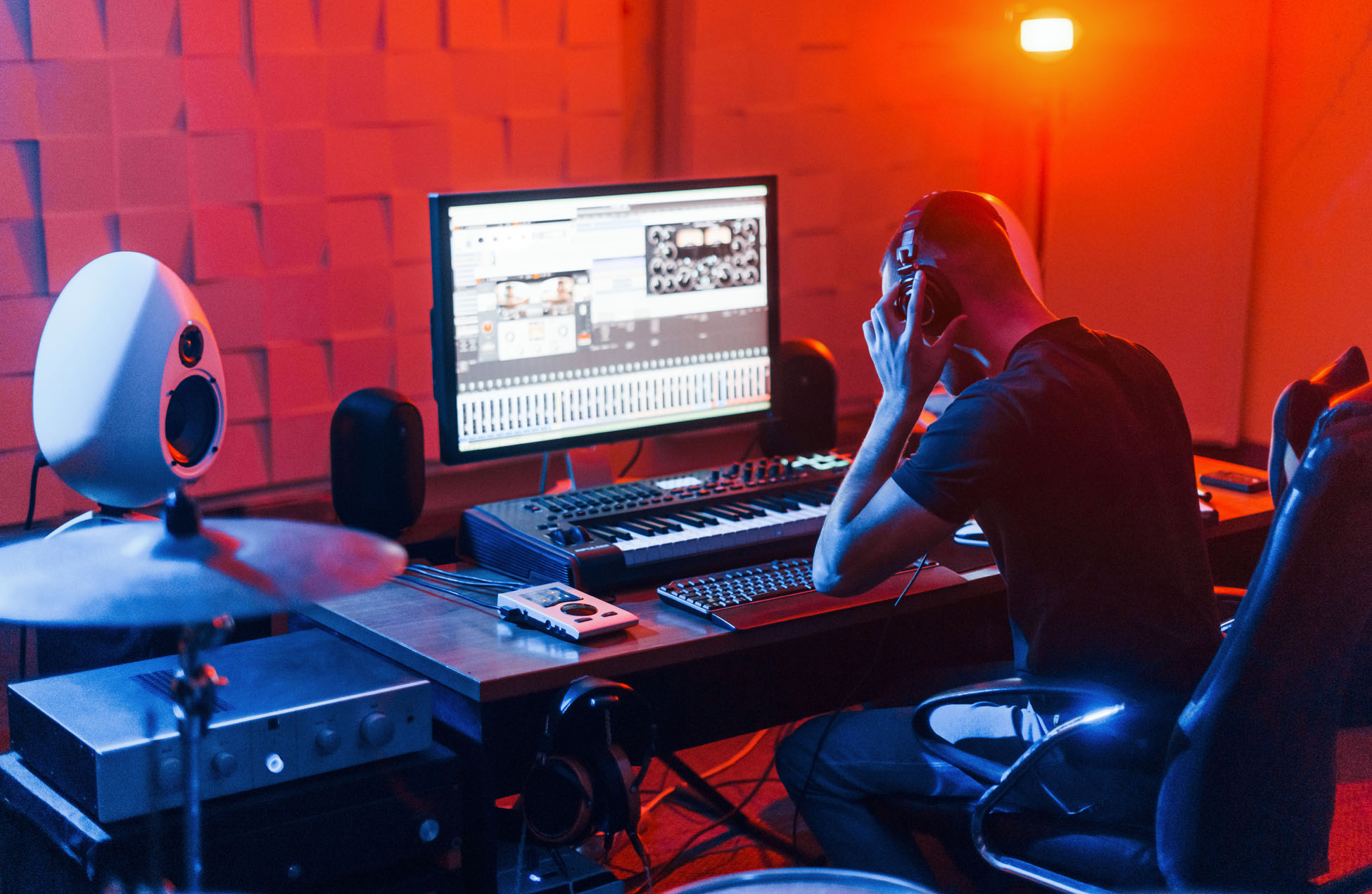 Guy have a job with project and mixing music indoors in the studio.