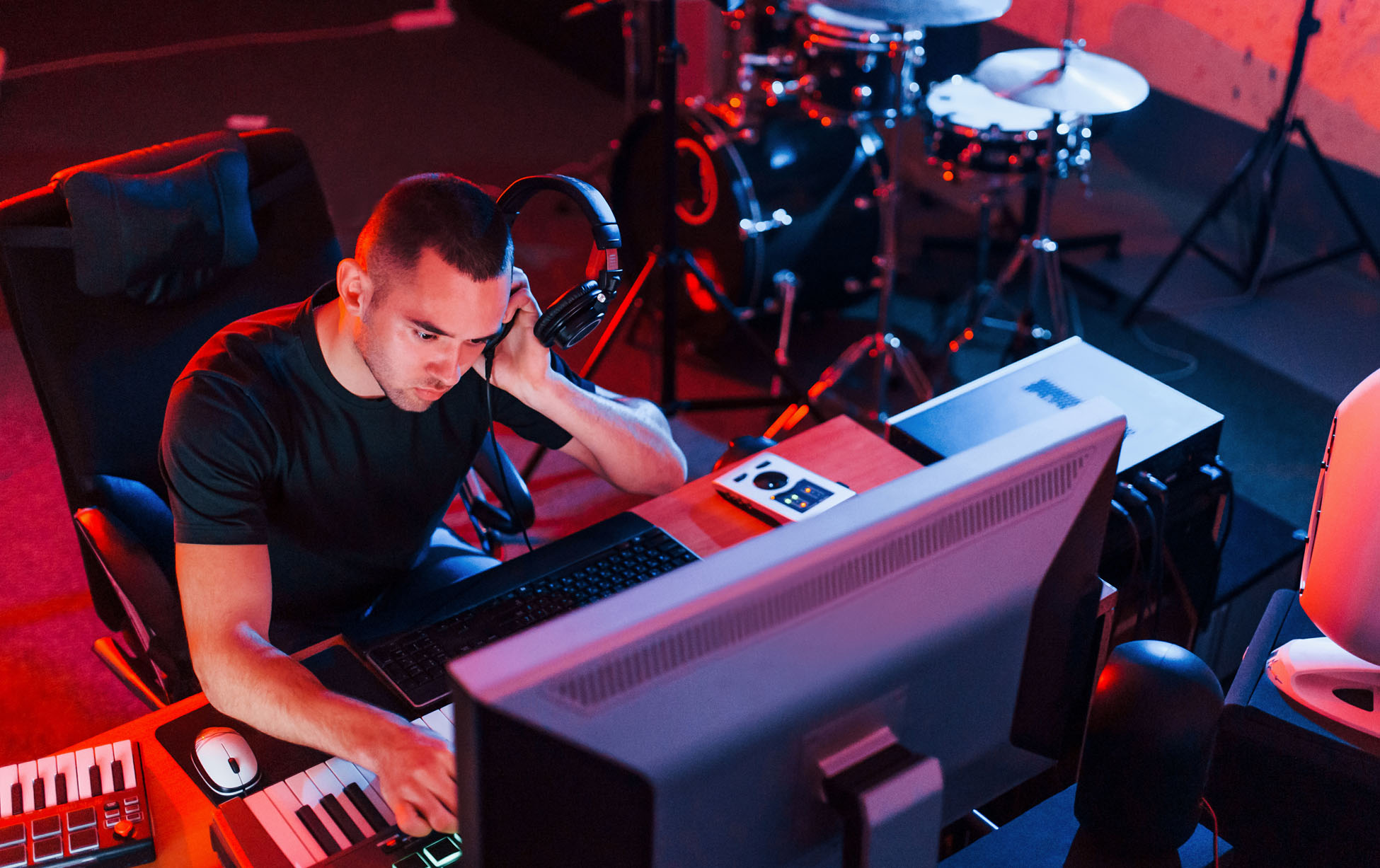 Professional sound engineer working and mixing music indoors in the studio.